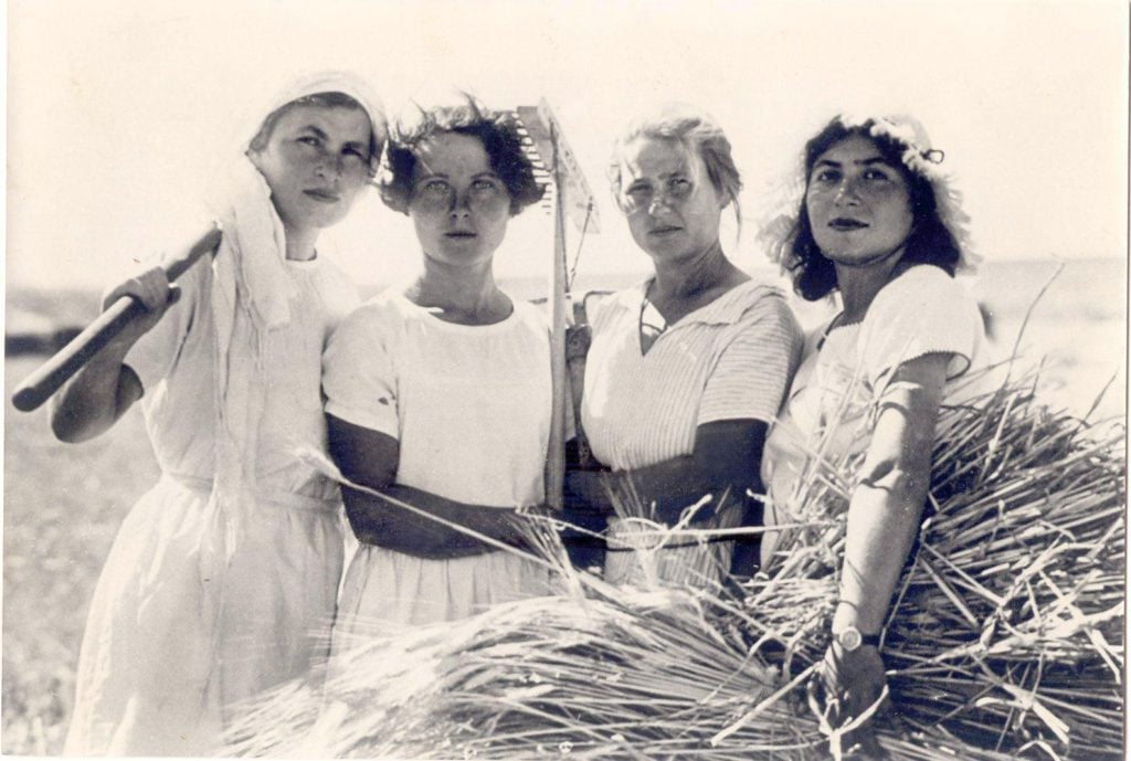 Women work the land of the Kibbutz. 