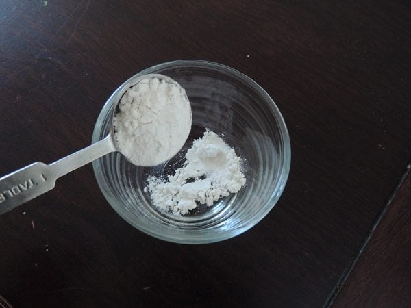 Adding flour to a little bowl. 