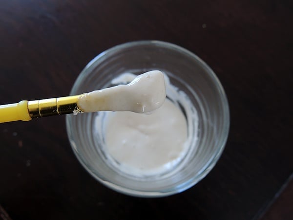 Mixing the water and flour to create a paste. 