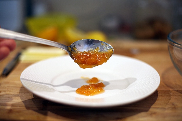 testing the thickness of the jam with a spoon