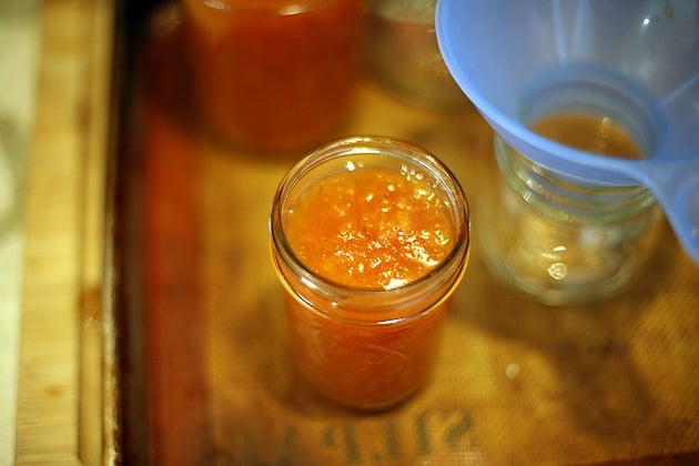 packing the jars with hot jam for canning