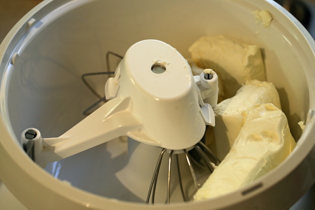 Adding cream cheese to mixer.