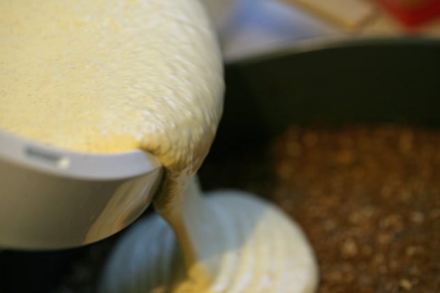 Pouring cheese mixture on the crust.