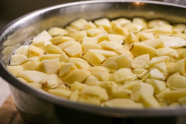 Soaking the apples in water to prevent browning.