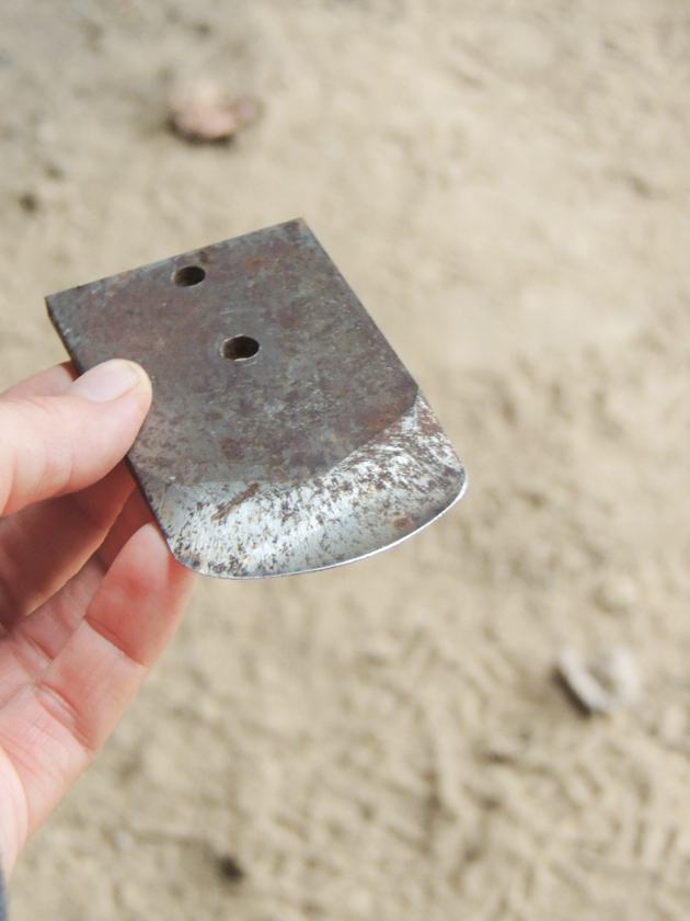 A piece of metal for softening a hide. 