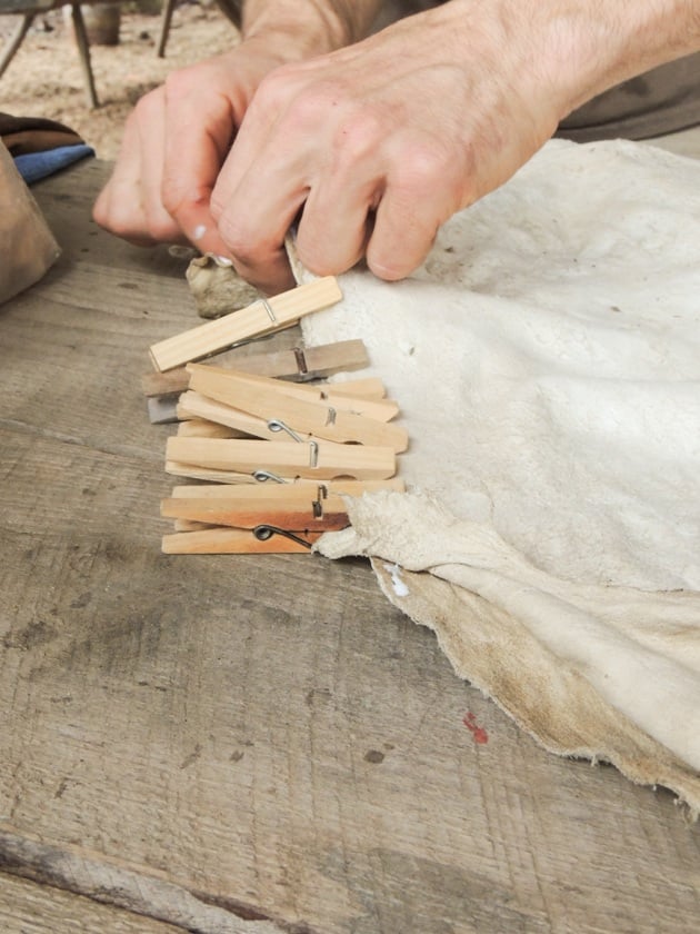 Using clothespins to hold the hides together. 