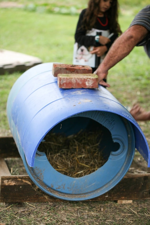 Placing a couple of bricks to hold the roof down until the glue dries. 