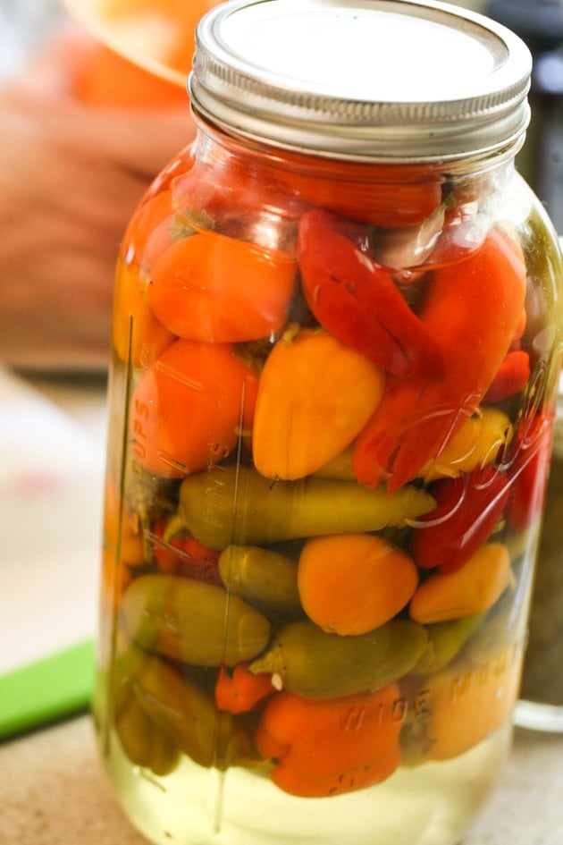 A jar of preserved peppers. 