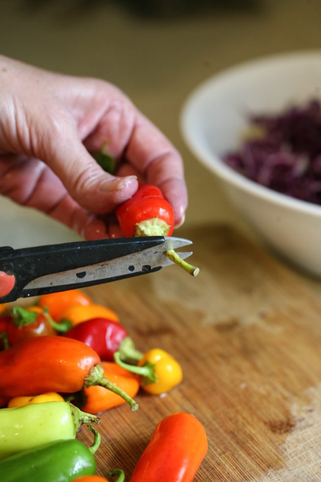 Cutting the stem of the pepper.