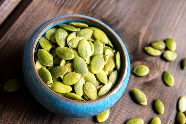 Discover 15 amazing pumpkin seeds health benefits. There are so many reasons why you should add pumpkin seeds to your diet! Lower the risk of diabetes, sleep better, prevent kidney stones, support the digestive system, and so much more! #seedspumpkin #pumpkinseedsbenefits #healthysnacks #pumpkinseedsnutrition #pumpkinseedshealth #pumpkinseeds #easysnacks #pumpkins #fallrecipes #falldishes #pumpkinseedsideas
