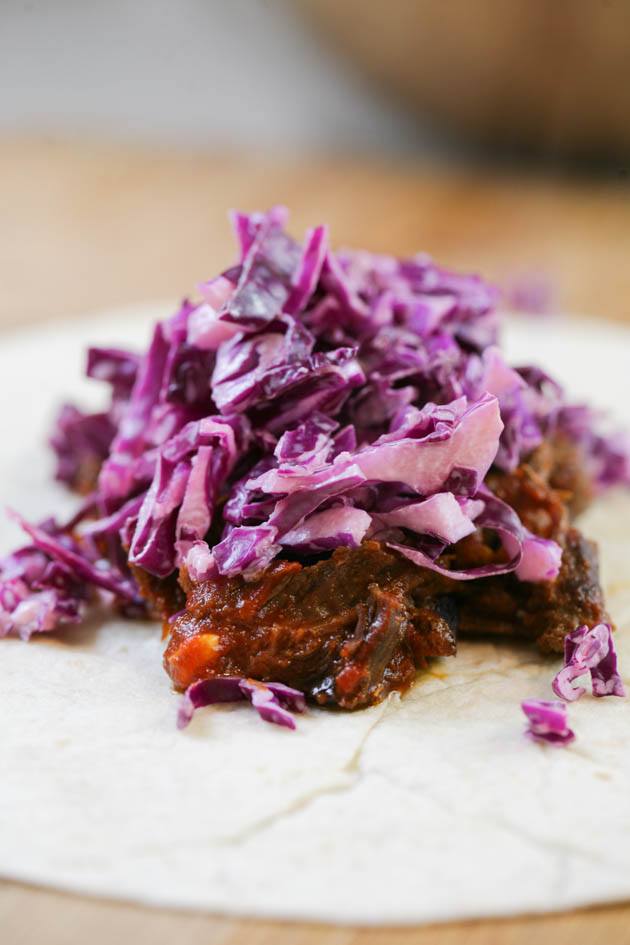 Pulled venison recipe. I used it in a wrap with a delicious red cabbage salad but it can also be a main dish along with a side of rice, mash potatoes, quinoa or anything else you like. The meat is soft and the sauce is delicious! #venison #venisonrecipes #howtocookvenison #deermeat #hunting #hunterfood #deermeatrecipes #huntingseason