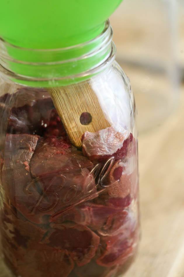 Adding meat to clean jar