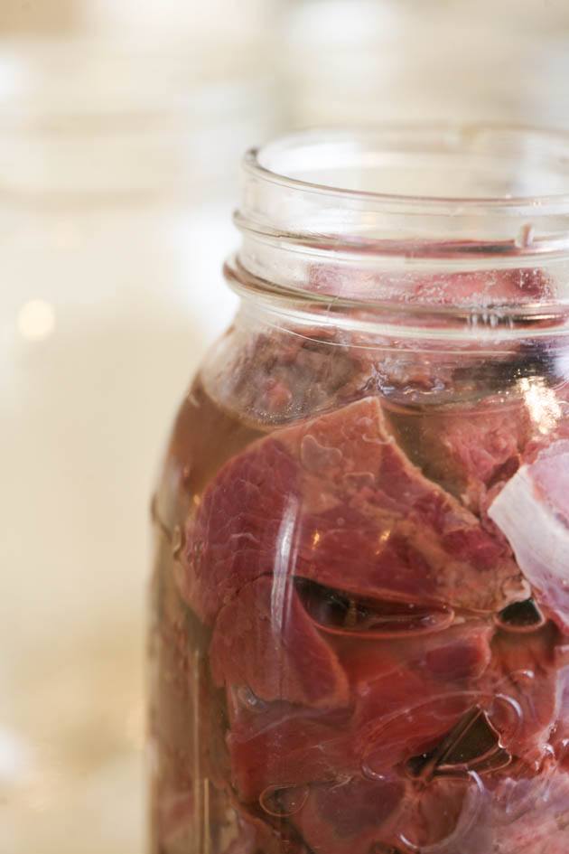 Adding liquid to the jar of meat