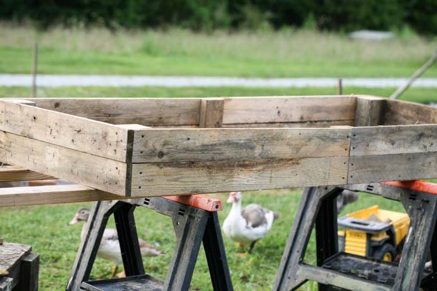 Painting the pallet wood garden bed.