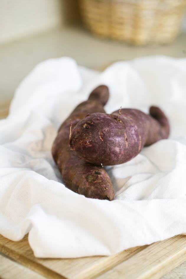 Preparing purple sweet potatoes for baking.