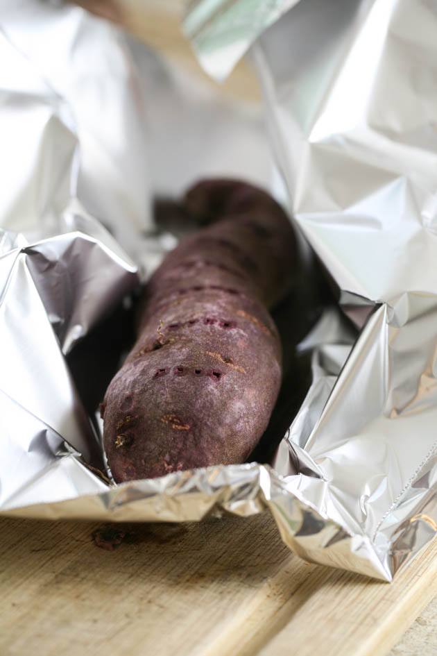 Wrapping the purple sweet potato in tin foil.