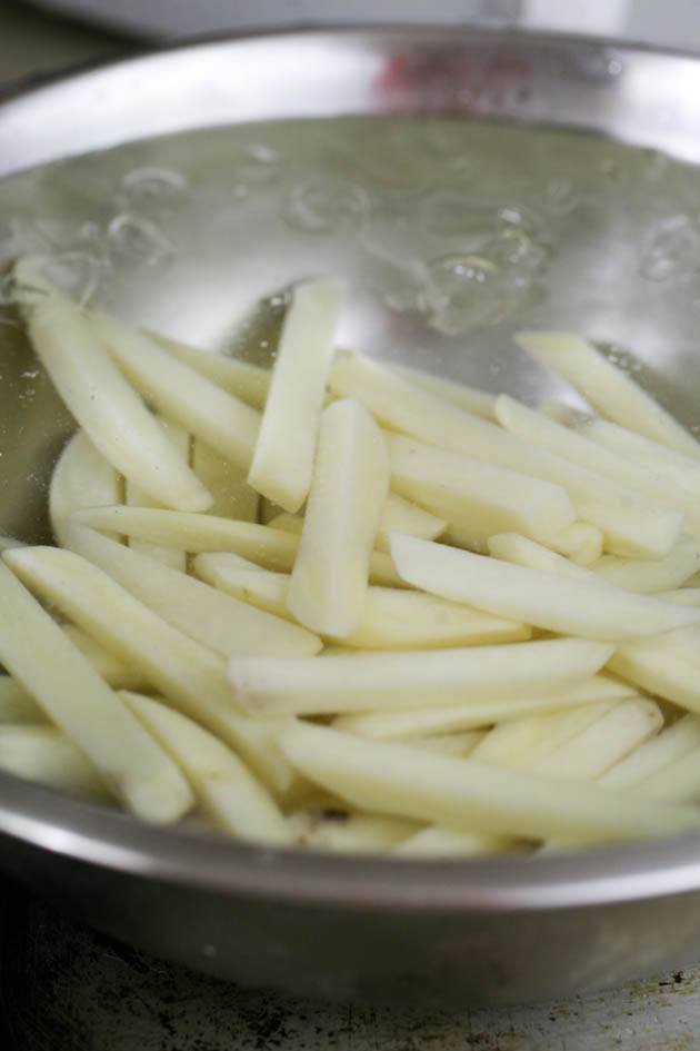 potatoes in a bowl of ice water after blanching