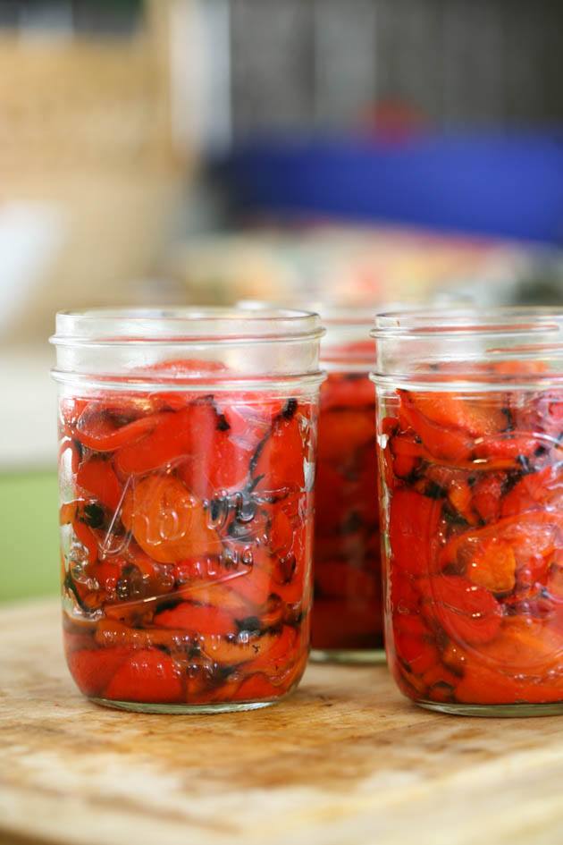 Jars are full of roasted red peppers.