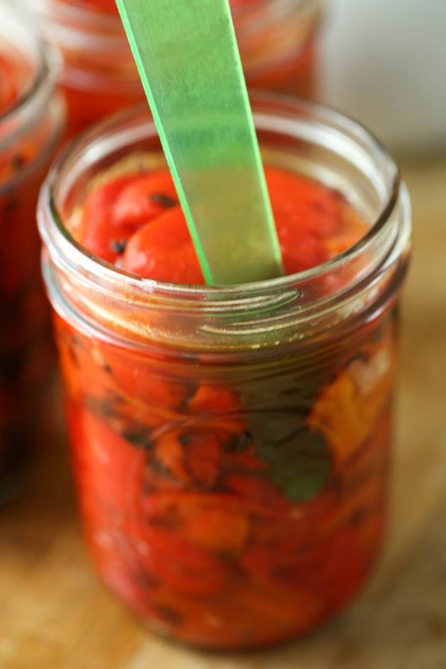 Removing bubbles from the jar of peppers with the bubble remover.