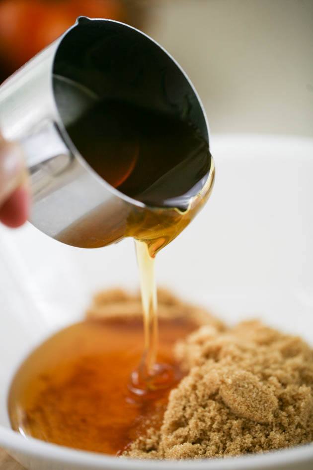 Adding honey to mixing bowl.