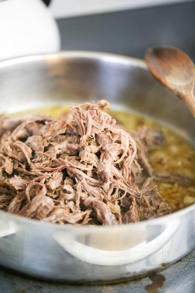 Adding venison neck meat to the pan.