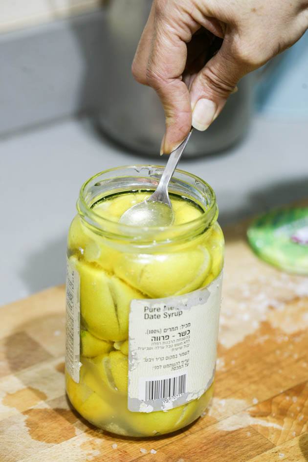 Pressing the lemons under the oil.