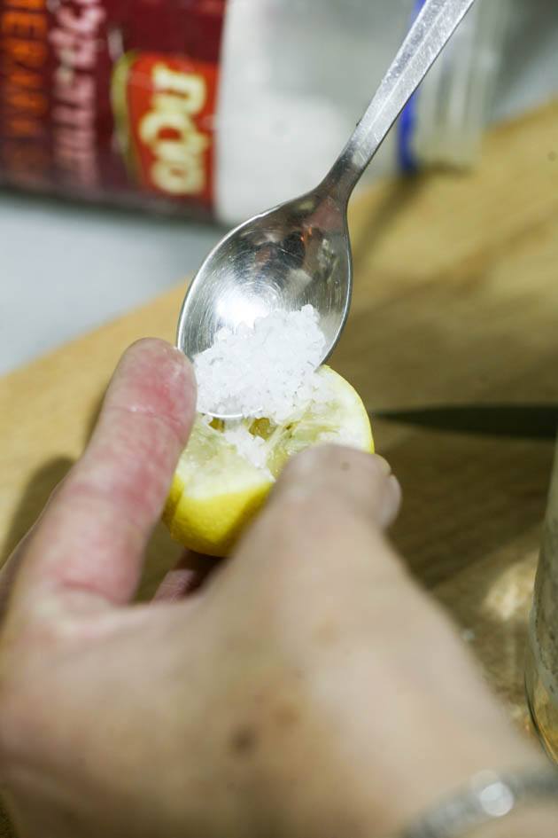 Adding salt in the center of the lemon.