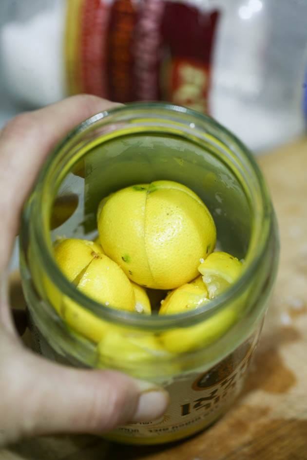 Packing more lemons into the jar.