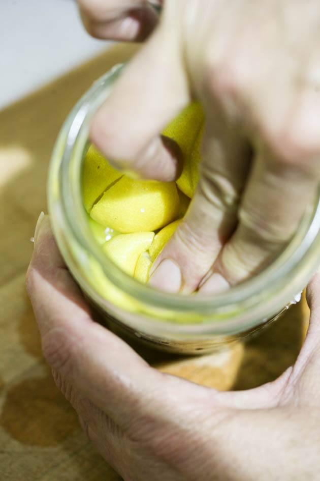 Pressing the lemons to release some juice.