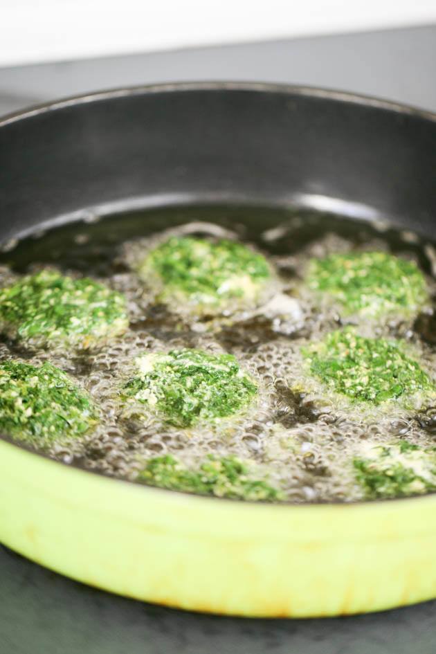 Frying the spinach patties.