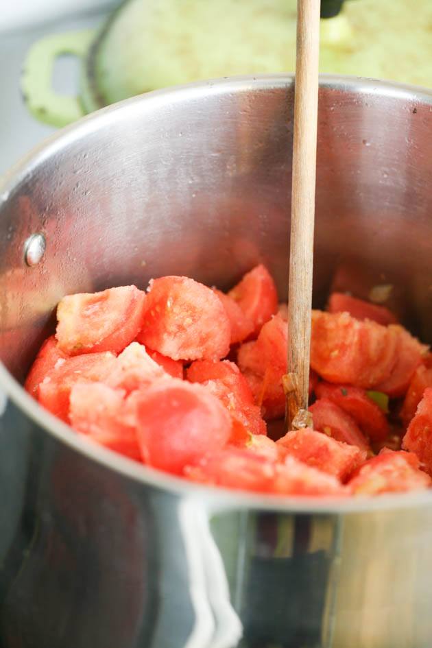 Frozen tomatoes cooking in a large pot. 