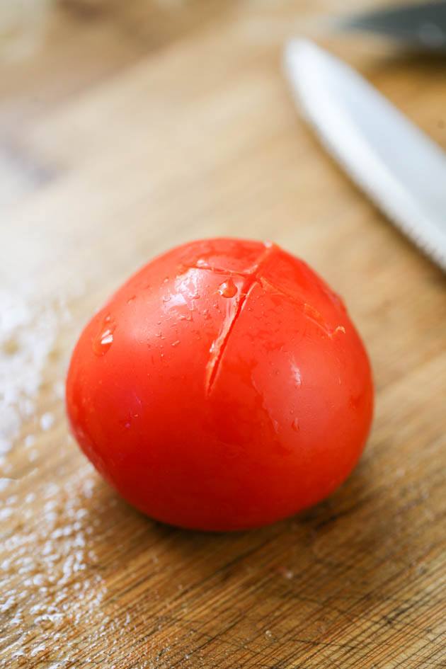 Peeling frozen tomatoes.