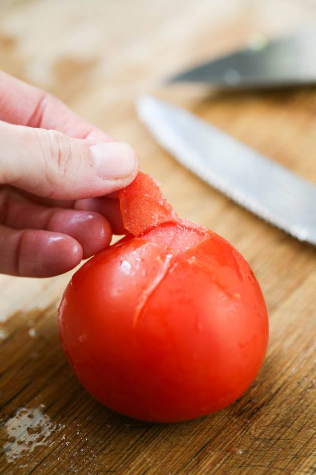 Peeling frozen tomatoes.