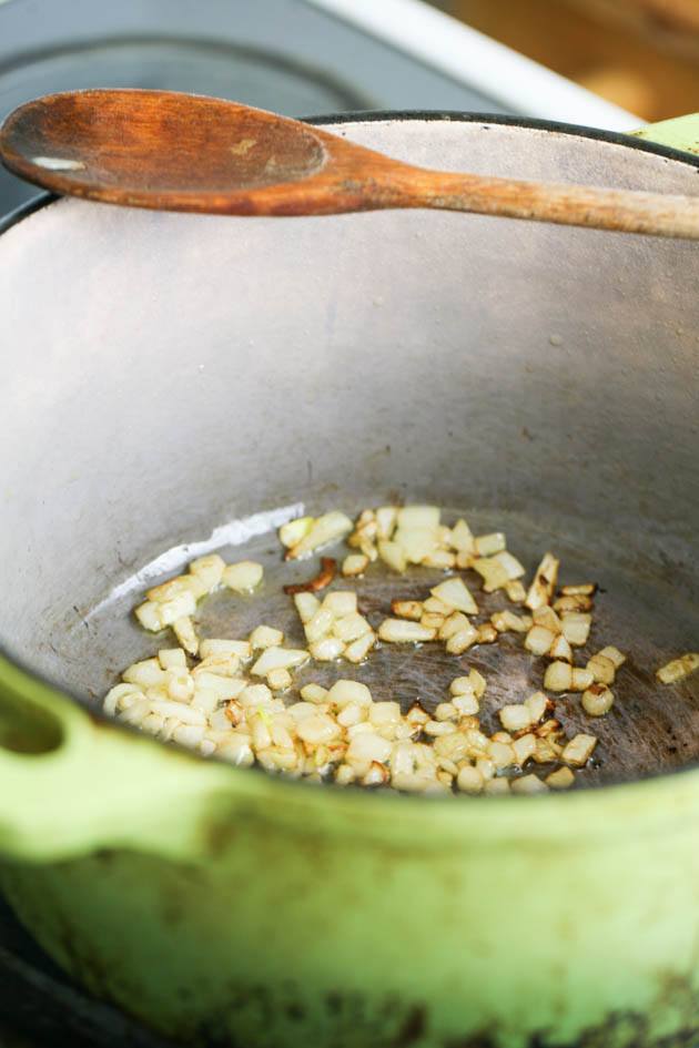 Cooking the diced onion until browned.