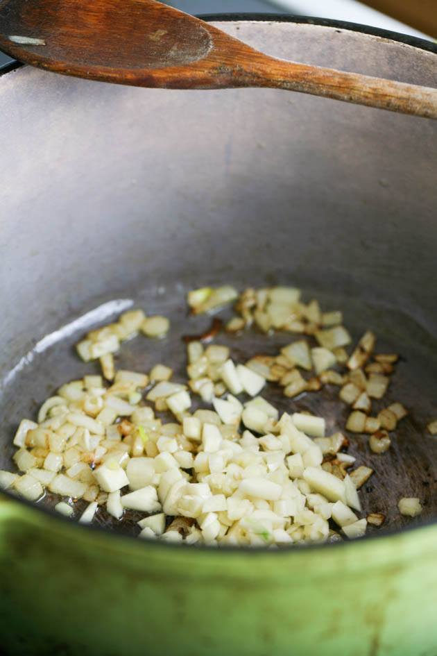 Adding the diced garlic to the pot.