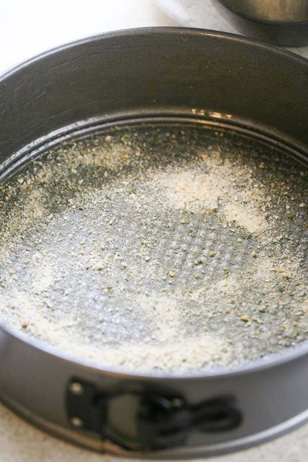 Adding bread crumbs to the bottom of the bowl. 