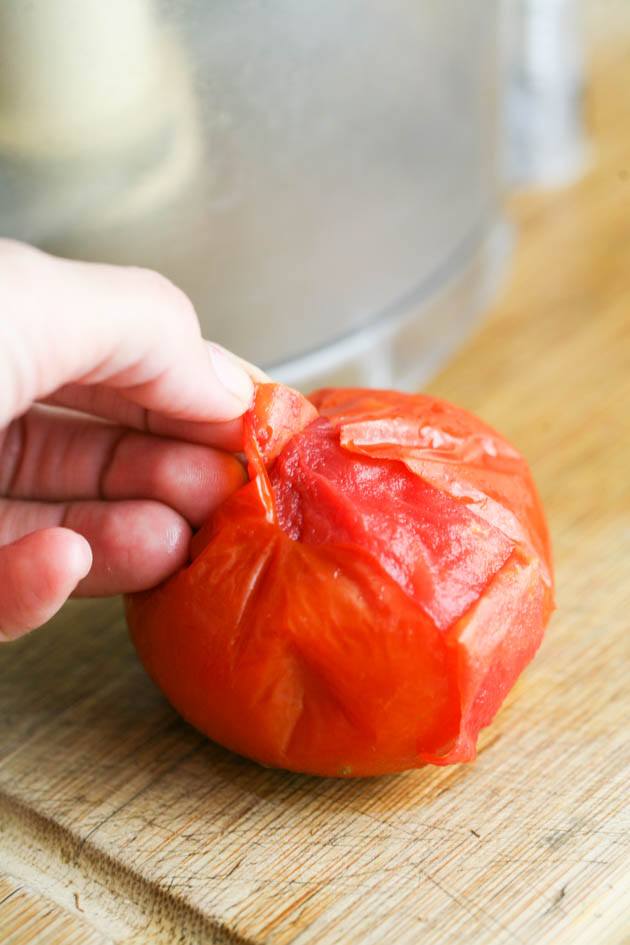Peeling a half-frozen tomato.