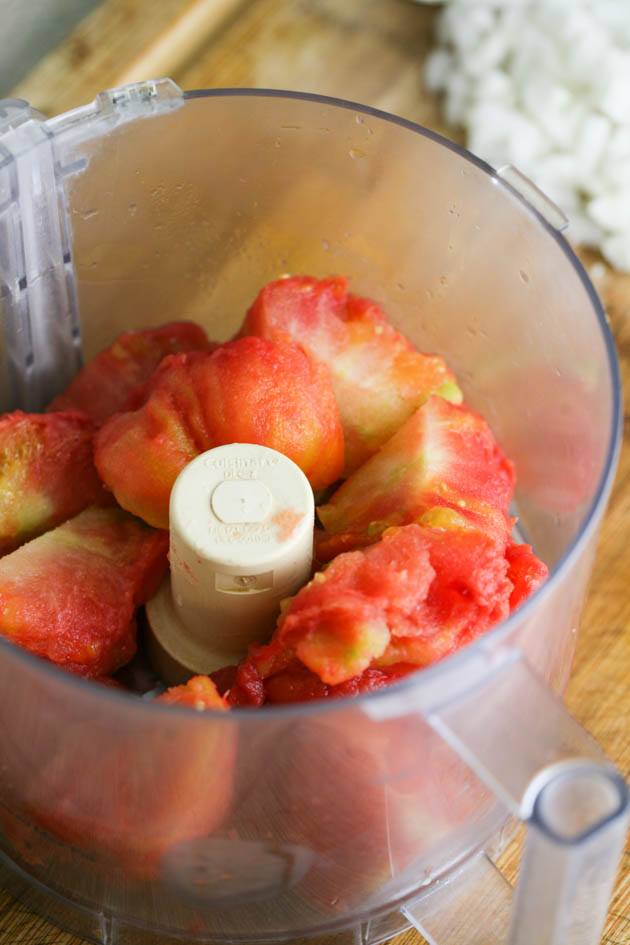 Frozen tomatoes in a the food processor.