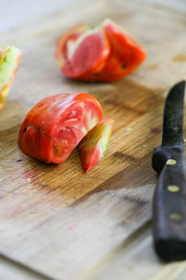 Removing the core of the tomato.