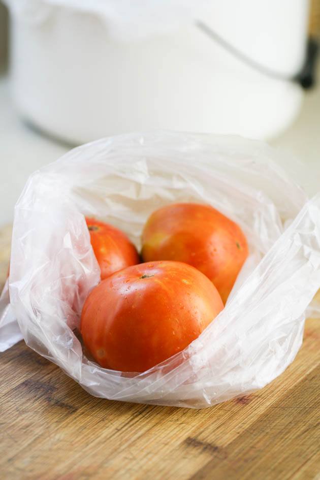 Whole tomatoes in a bag ready for freezing.