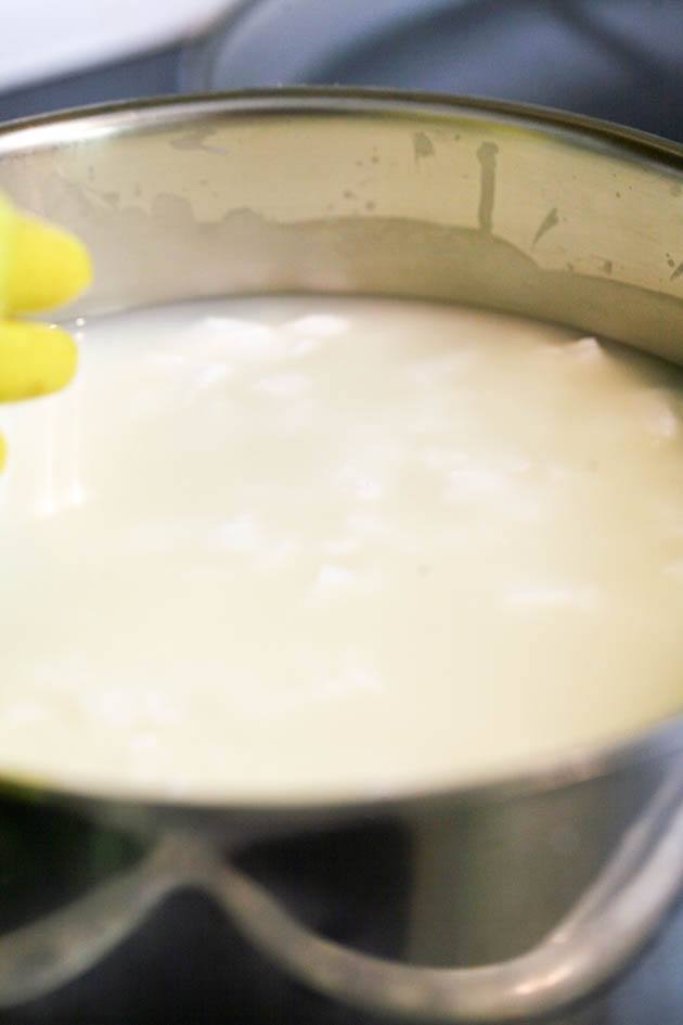 Heating the raw goat milk cheese. 