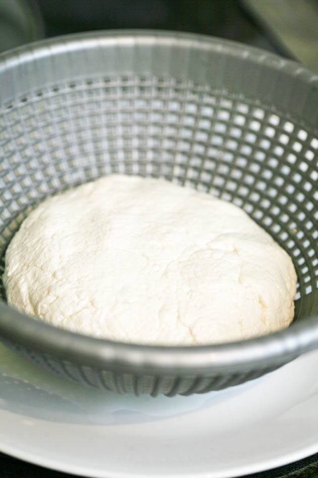 Placing the cheese in the mold. 