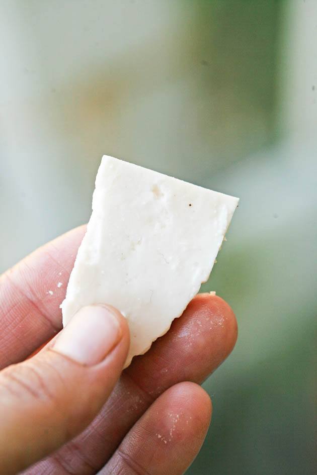 A slice of raw goat milk cheese.