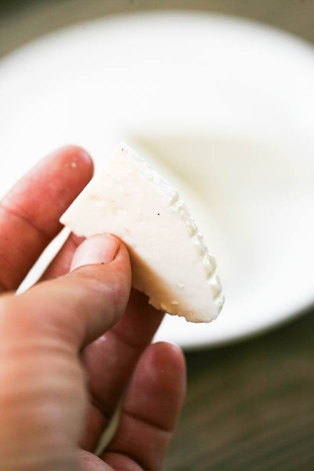 A slice of raw goat milk cheese.