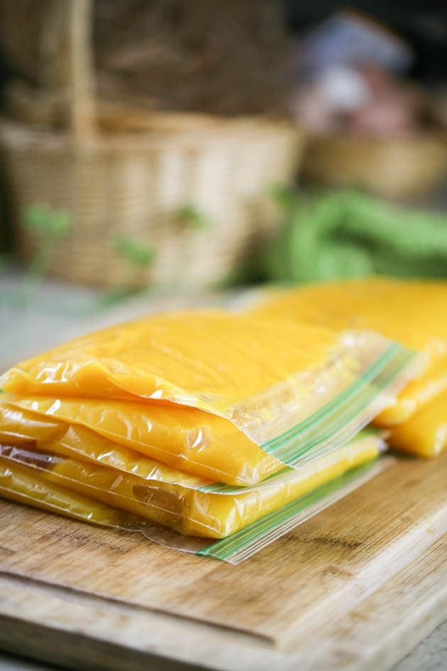 Adding pumpkin puree into ziplock bags. 