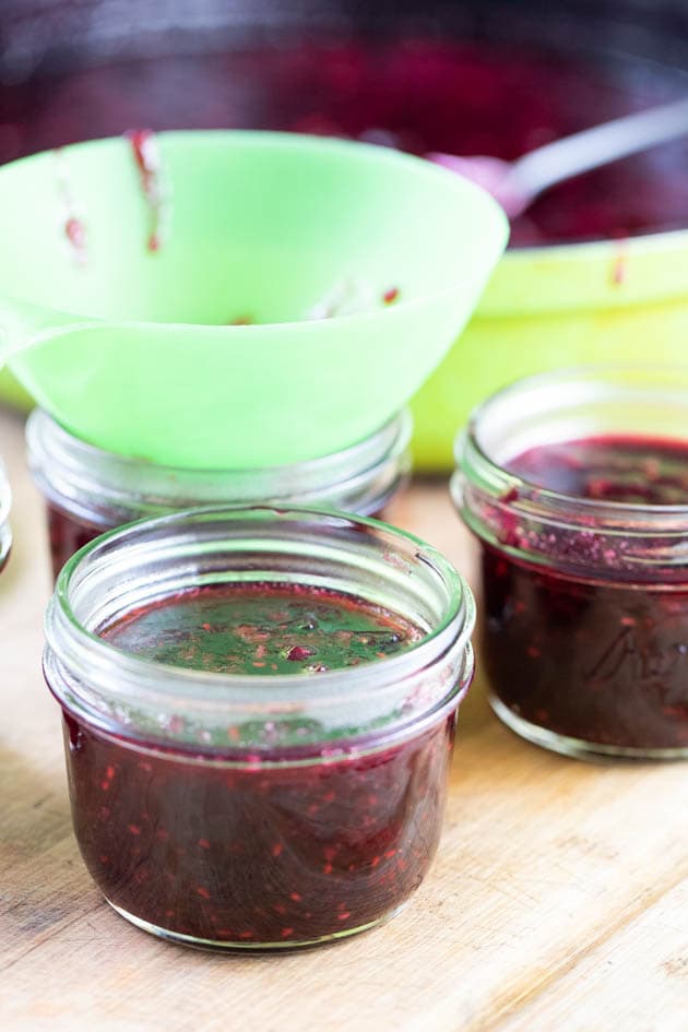 Filling the jars with mixed berry jam