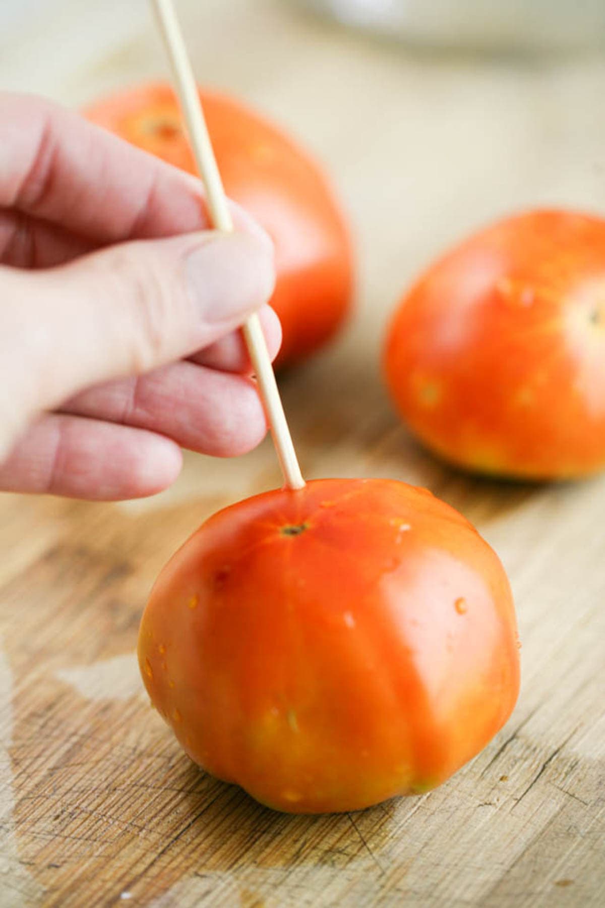 Poking the tomatoes to allow the brine in. 