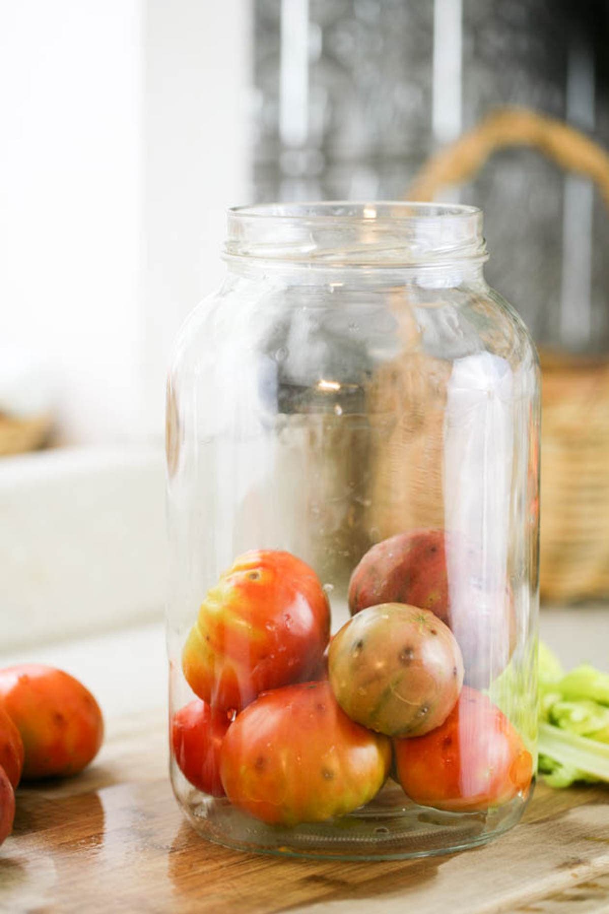 Adding tomatoes to the jar.