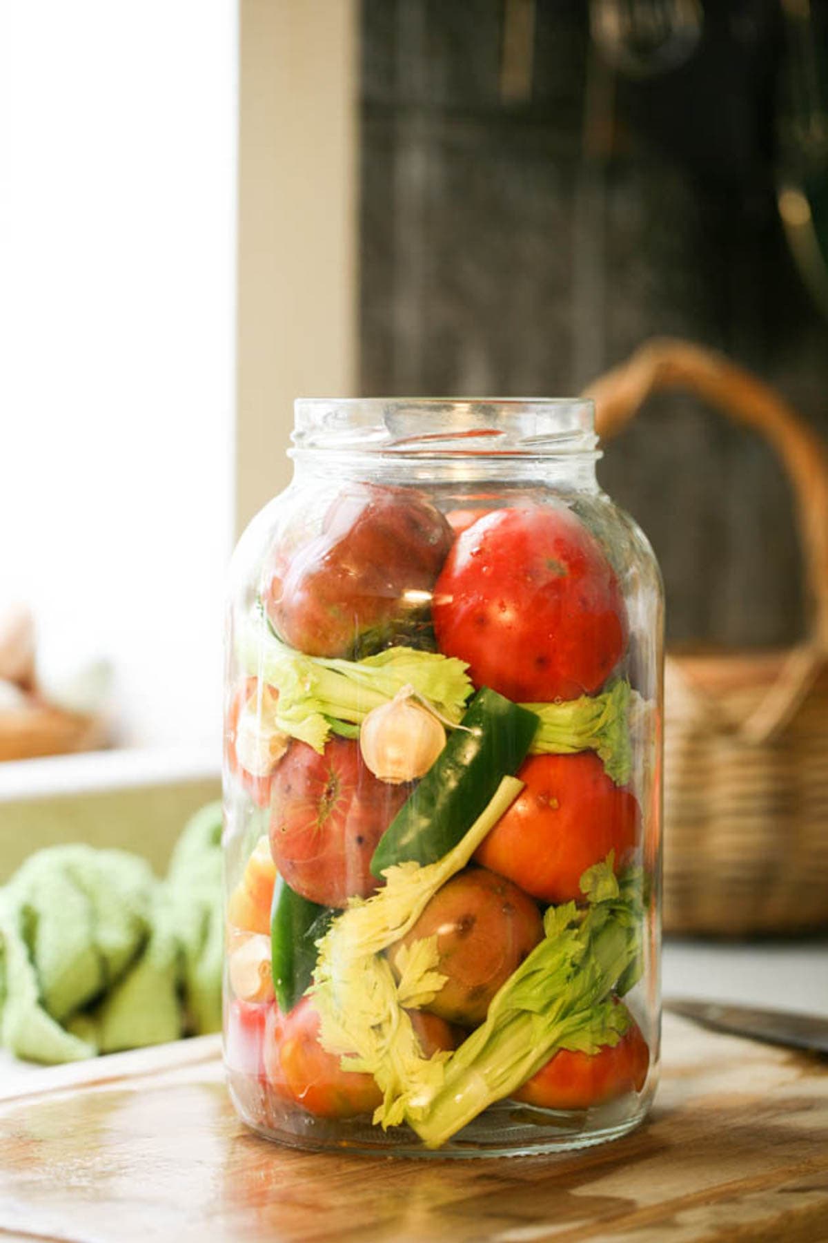 Filling the jar to the top with tomatoes.