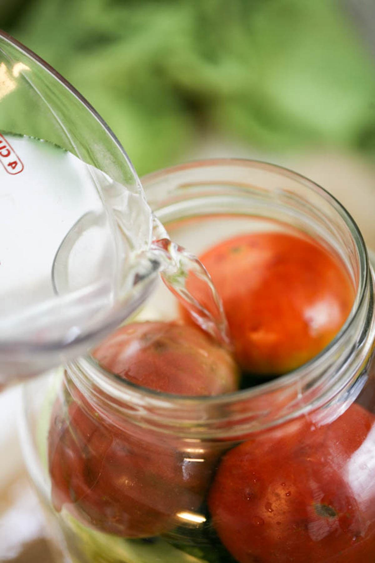 Adding brine to the jar.